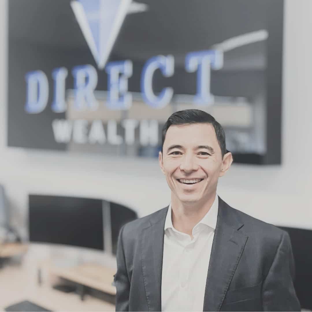 A photo of financial advisor Brett Seet in front of the Direct Wealth sign.
