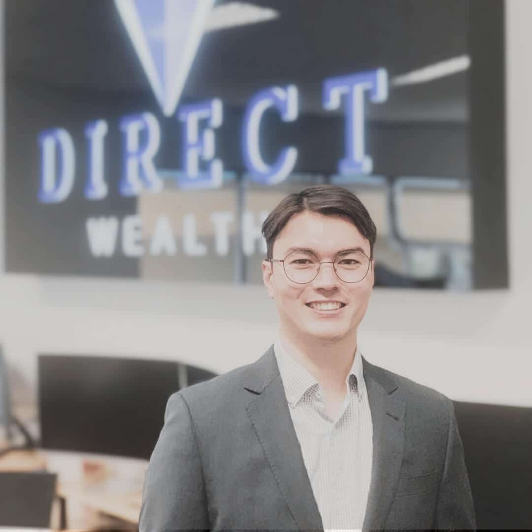 A photo of Caillin Chia in front of the Direct Wealth sign.