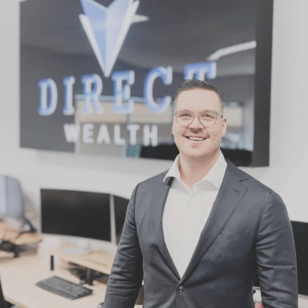 A picture of financial advisor Daniel Westerman in front of the Direct Wealth sign.