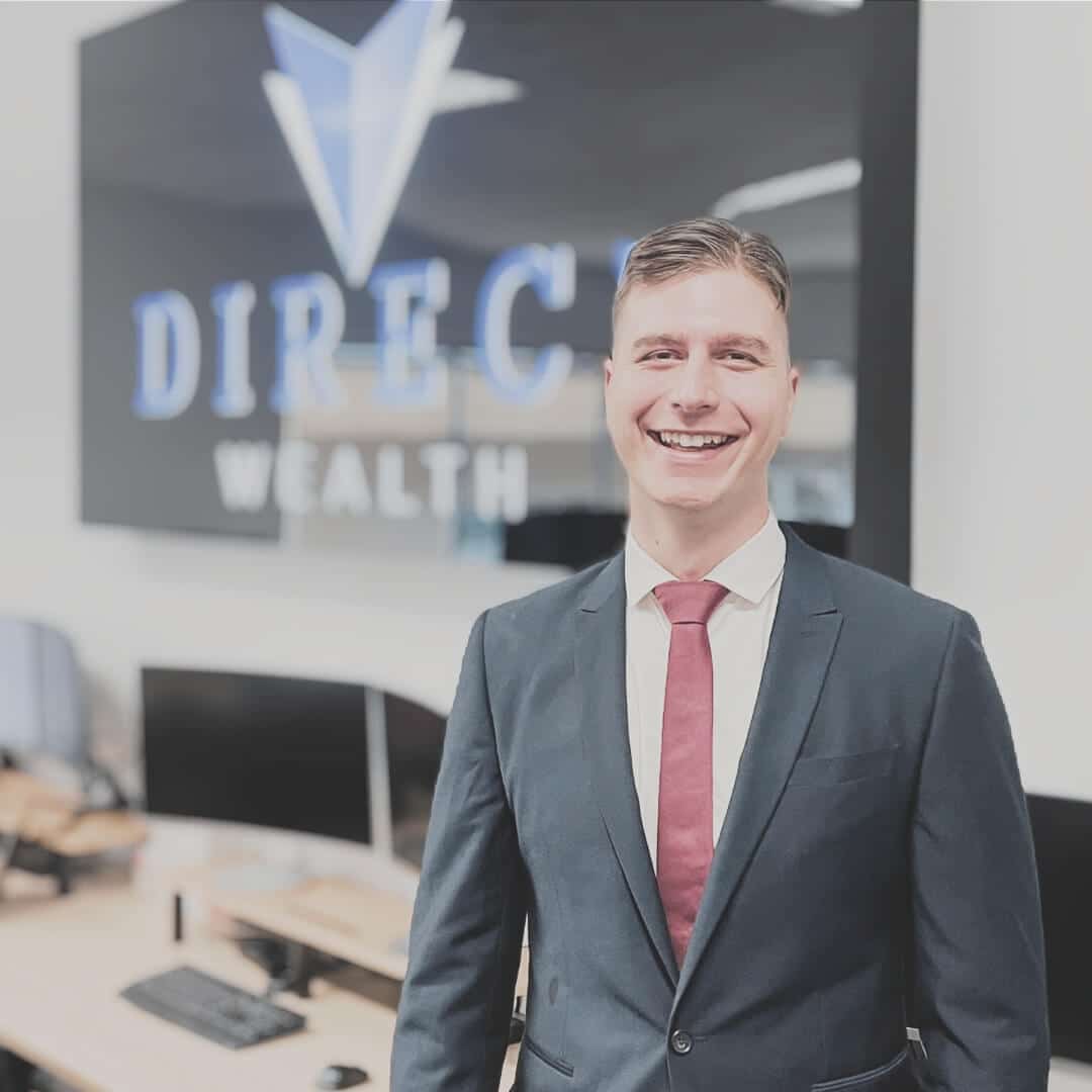 A photo of financial advisor Sam Carter in front of the Direct Wealth sign.