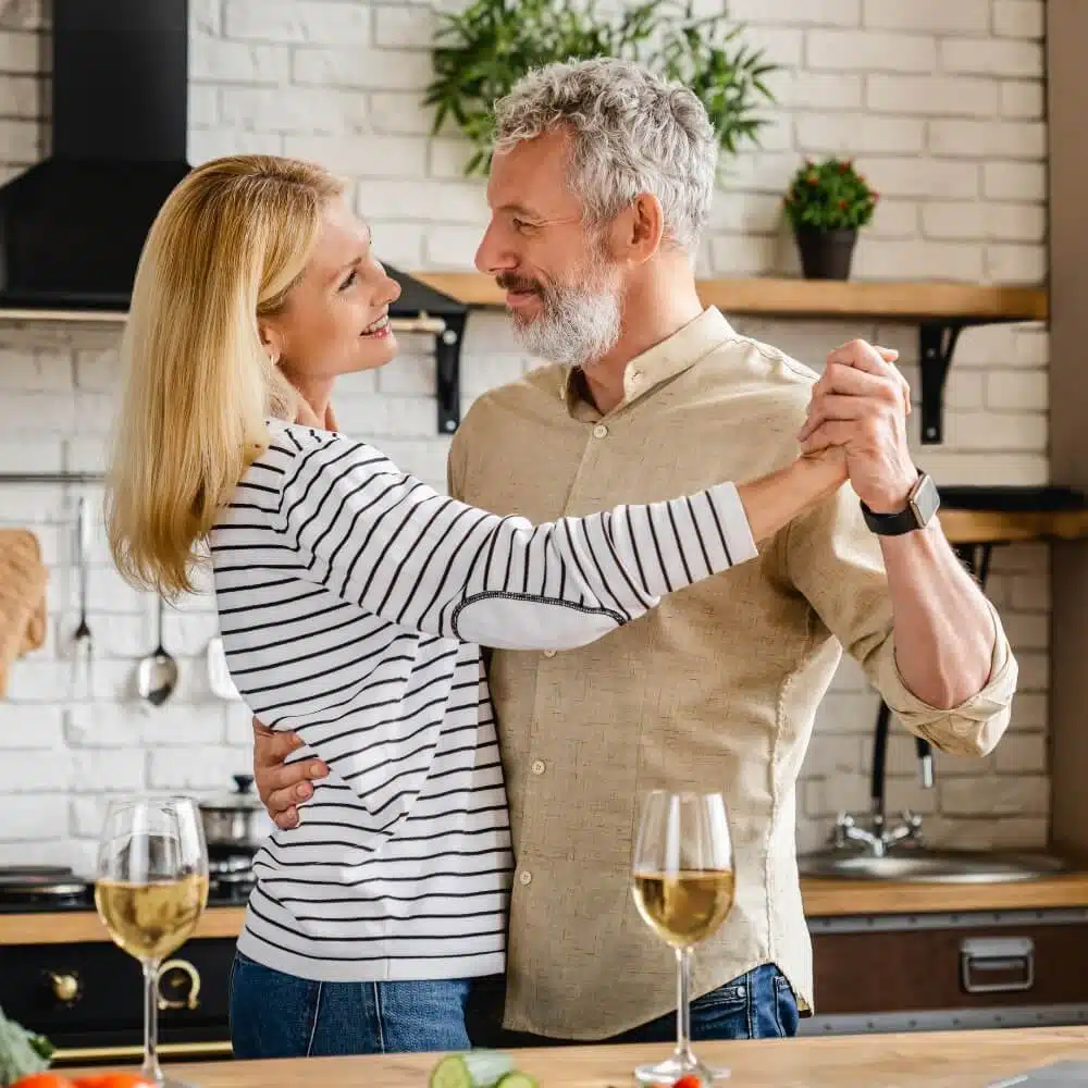 A couple dance in their kitchen.