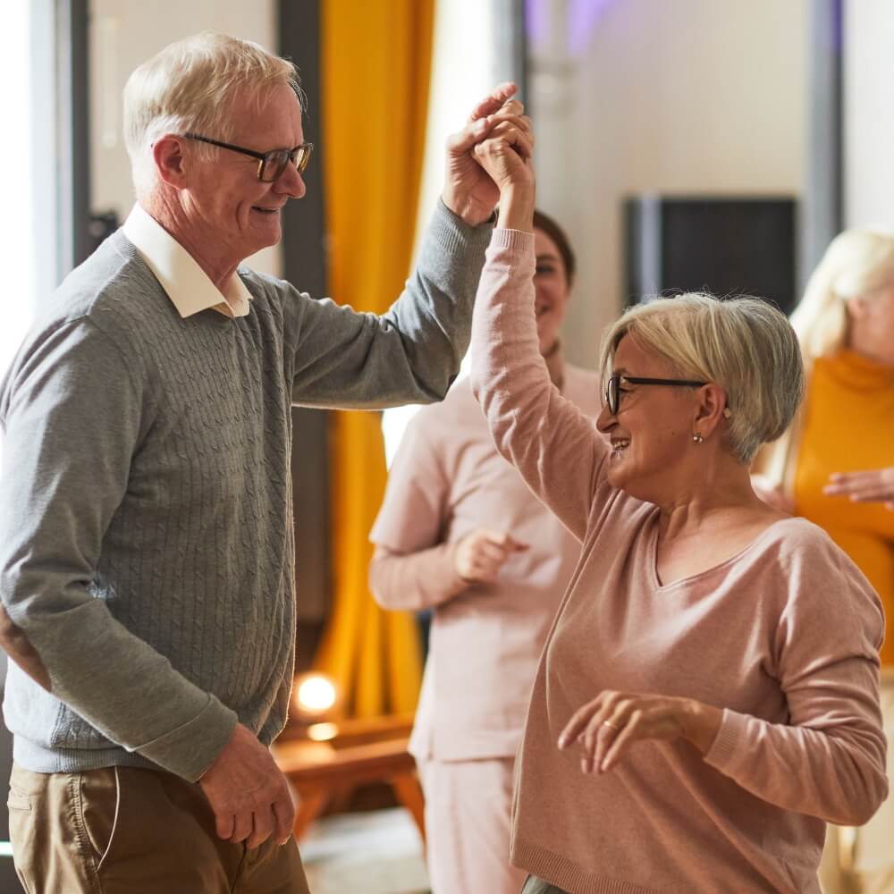 Happy senior couple dancing – Start planning today with expert financial advisors in Ipswich at Direct Wealth.