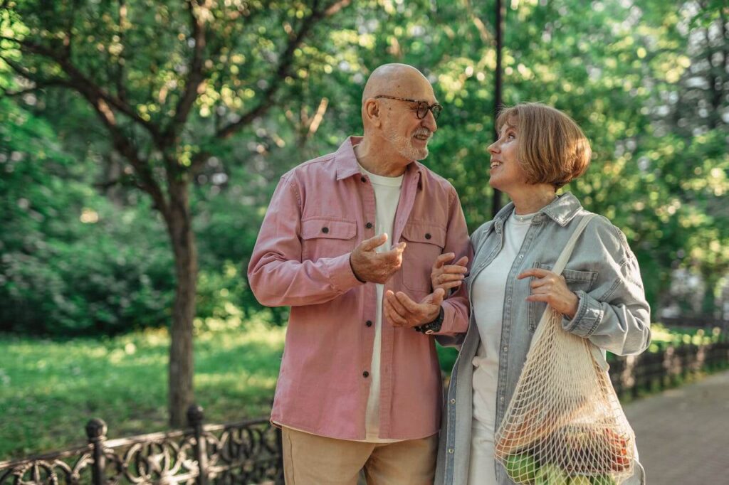 Older couple enjoying a relaxed walk outdoors, representing a comfortable retirement lifestyle in Australia