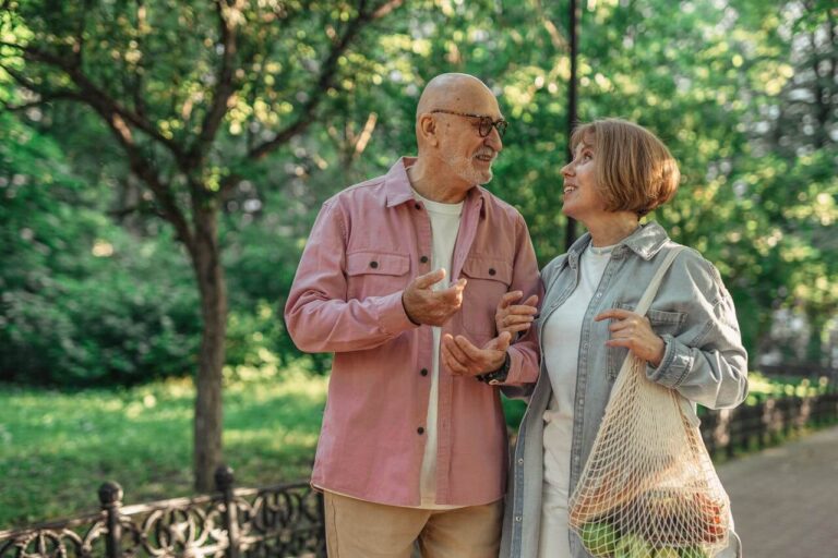 Older couple enjoying a relaxed walk outdoors, representing a comfortable retirement lifestyle in Australia