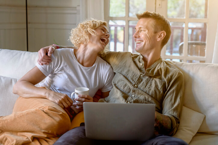 Couple discussing financial advice in Brisbane at home with laptop